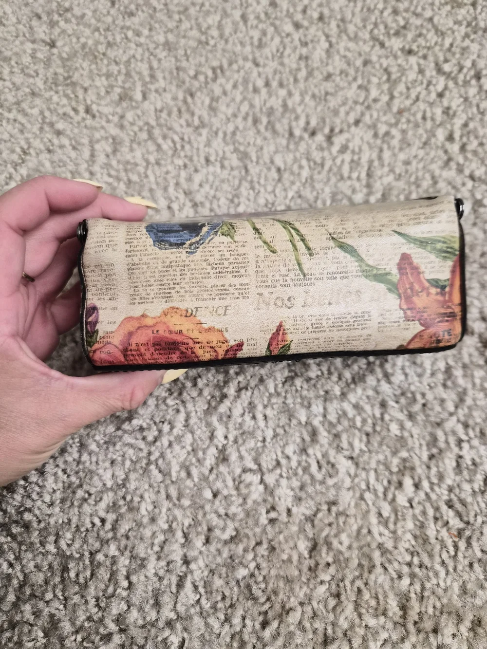 This is a Patricia Nash kiss-lock frame clutch with a built-in mirror